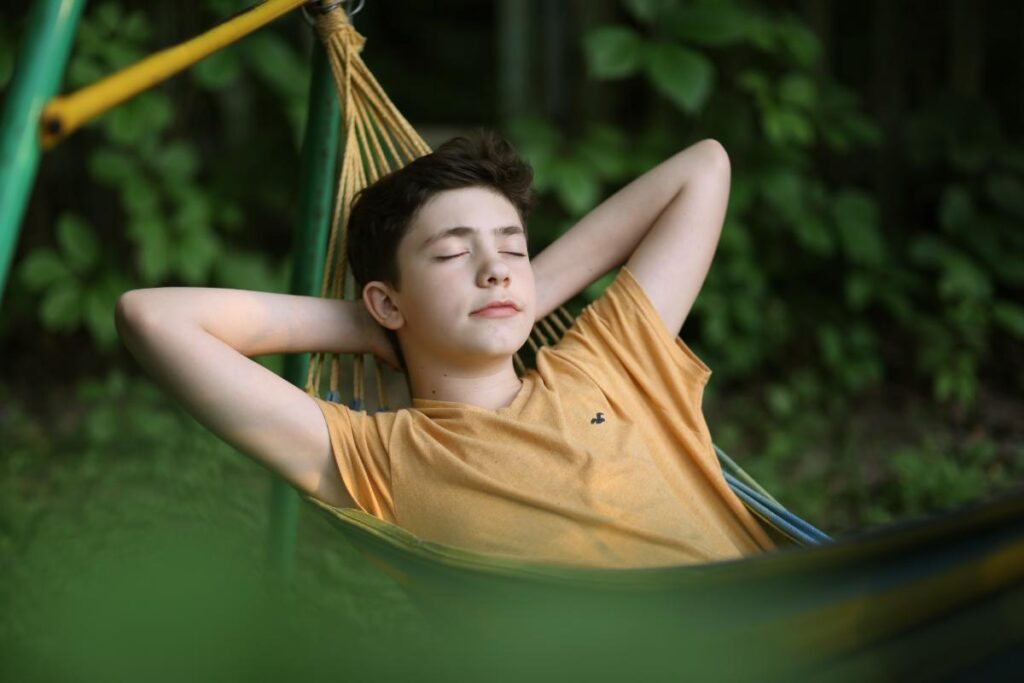 teen resting in hammock as one of many self care activities for teens