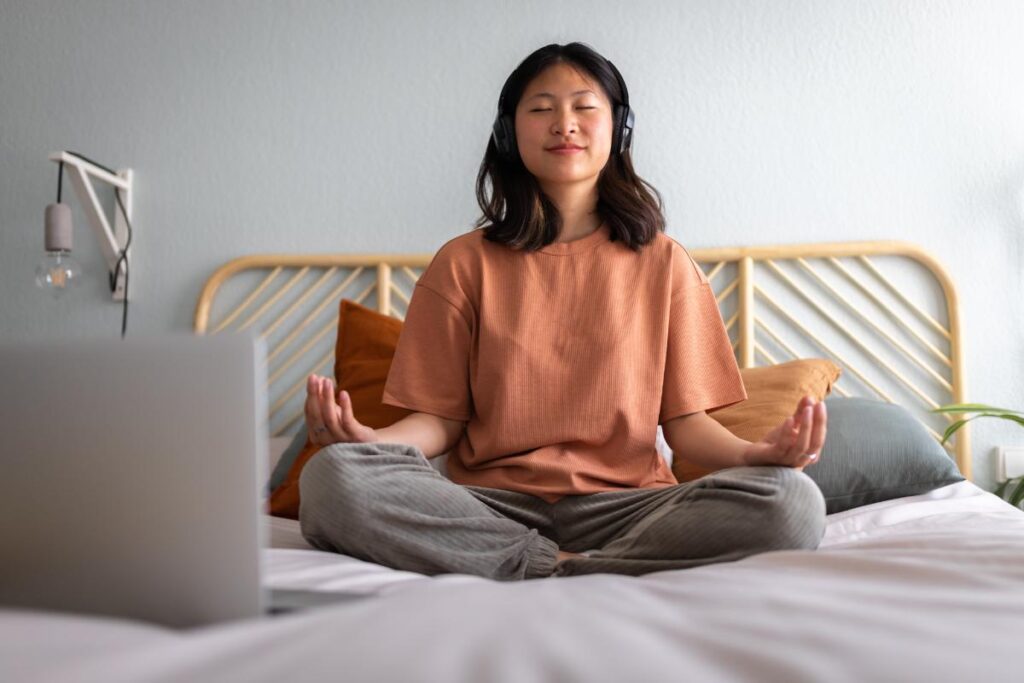 teen meditating in bed after learning tips for morning anxiety