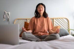 teen meditating in bed after learning tips for morning anxiety